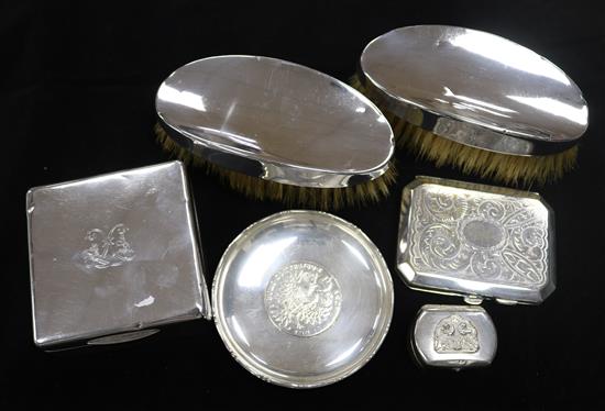 A silver cigarette box, a pair of silver back brushes, etc.